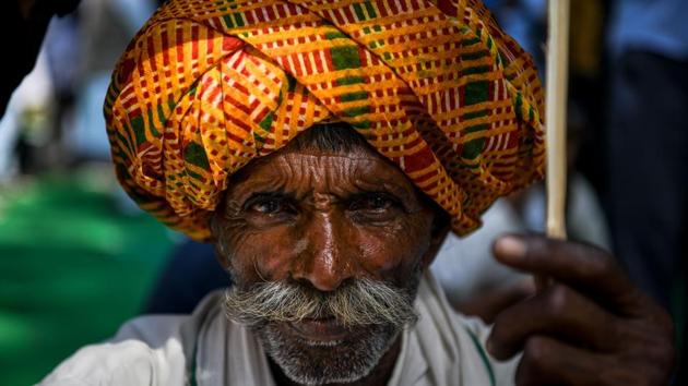 Farmer Ganesh Narayan, 55, looks on as he sits on a protest against the central government over various demand in favour of farmers in New Delhi. (Chandan Khanna / AFP)