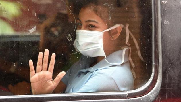 A girl covers her face with a mask to protect from the city’s rising pollution levels in New Delhi (Raj K Raj / HT Photo)