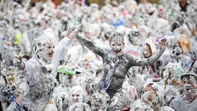 Students from St Andrews University, many in fancy dress, indulge in a tradition of covering themselves with foam to honour the ‘academic family’ on the lower college lawn in St Andrews, Scotland. (Jeff J Mitchell / Getty Images) Students from St Andrews University, many in fancy dress, indulge in a tradition of covering themselves with foam to honour the ‘academic family’ on the lower college lawn in St Andrews, Scotland. (Jeff J Mitchell / Getty Images)