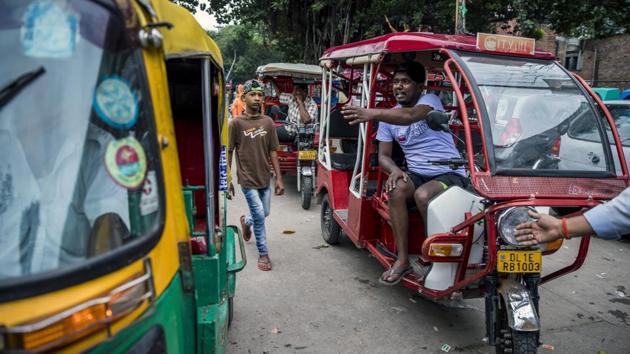 Drivers of the ubiquitous three-wheelers weaving through crowded, smoggy streets discovered that e-rickshaws are quieter, faster, cleaner and cheaper to maintain than a traditional auto rickshaw. They also are less strenuous than cycle rickshaws, which require all-day peddling. So with more rides possible in a day, the e-rickshaws are proving more lucrative. (Prashanth Vishwanathan / Bloomberg) Drivers of the ubiquitous three-wheelers weaving through crowded, smoggy streets discovered that e-rickshaws are quieter, faster, cleaner and cheaper to maintain than a traditional auto rickshaw. They also are less strenuous than cycle rickshaws, which require all-day peddling. So with more rides possible in a day, the e-rickshaws are proving more lucrative. (Prashanth Vishwanathan / Bloomberg)