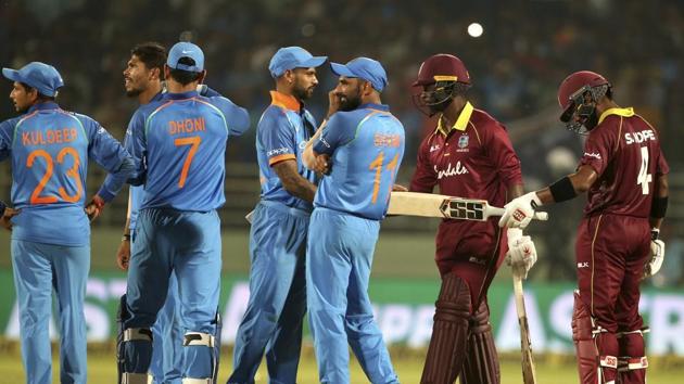 West Indies' batsmen Shai Hope, right, and Kemar Roach, second right, react as they stand next to Indian players after the second one-day international cricket match between India and West Indies.(AP)