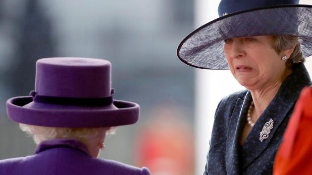 Britain’s Prime Minister Theresa May (R) reacts as she is greeted by Britain’s Queen Elizabeth II (C) on the dias as they take their places for a ceremonial welcome for King Willem-Alexander and Queen Maxima of the Netherlands on Horse Guards Parade in London, at the start of the Dutch King and Queen's two-day state visit. (Matt Dunham / AFP) Britain’s Prime Minister Theresa May (R) reacts as she is greeted by Britain’s Queen Elizabeth II (C) on the dias as they take their places for a ceremonial welcome for King Willem-Alexander and Queen Maxima of the Netherlands on Horse Guards Parade in London, at the start of the Dutch King and Queen's two-day state visit. (Matt Dunham / AFP)