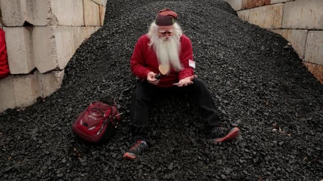 Santa School student Jerry Julian of Colorado Springs, Colorado sits in the coal pile of Pere Marquette 1225 steam train contemplating which bad kids will receive a piece of coal for Christmas, in Owosso, Michigan. (Jeff Kowalsky / AFP) Santa School student Jerry Julian of Colorado Springs, Colorado sits in the coal pile of Pere Marquette 1225 steam train contemplating which bad kids will receive a piece of coal for Christmas, in Owosso, Michigan. (Jeff Kowalsky / AFP)