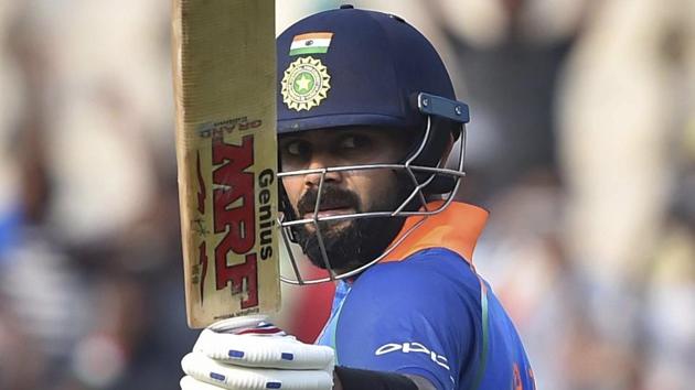 Virat Kohli raises his bat after scoring his century against West Indies.(PTI)