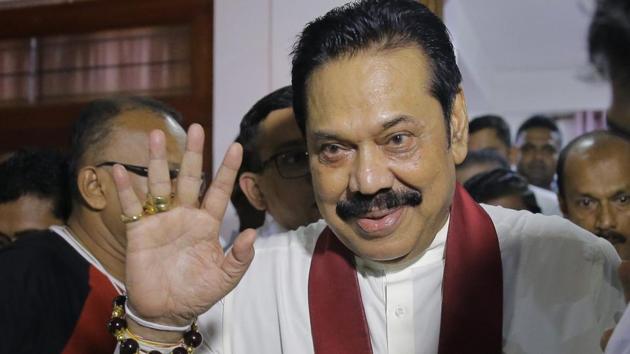 Newly appointed Sri Lankan prime minister Mahinda Rajapaksa leaves a Buddhist temple after meeting his supporters in Colombo, Sri Lanka, Friday.(AP Photo)