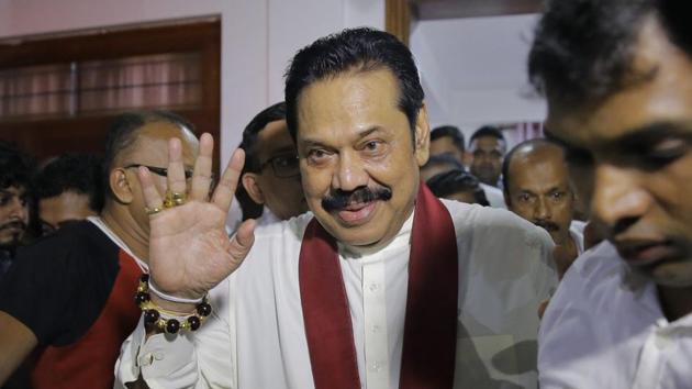 Newly appointed Sri Lankan Prime Minister Mahinda Rajapaksa, centre, leaves a Buddhist temple after meeting his supporters in Colombo, Sri Lanka, October 26, 2018 (AP)
