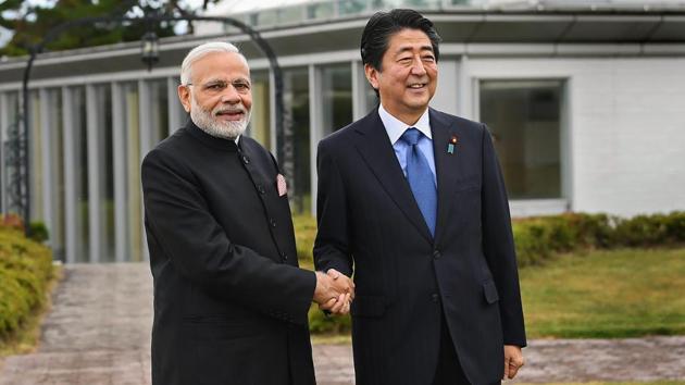 Prime Minister Narendra Modi shakes hands with his Japanese counterpart Shinzo Abe, at Yamanashi, Japan on Sunday.(PTI Photo)
