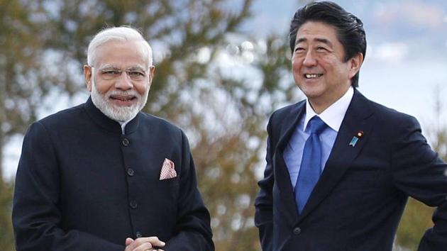 Prime Minister Narendra Modi and Japan's Prime Minister Shinzo Abe pose for a photo at a hotel garden in Yamanakako village, Yamanashi prefecture, Sunday, Oct. 28, 2018.(Suo Takekuma/Kyodo News via AP)