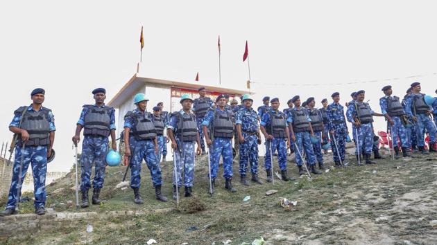 RAF personnel stand guard during Antarrashtria Hindu Parishad president Pravin Togadia's rally near the 'samadhi' of Ram Chandra Paramhans, in Ayodhya.(PTI Photo)