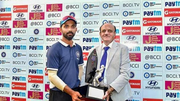 BCCI Acting President C K Khanna presents D. B. Deodhar Winner Trophy to Ajinkya Rahane, captain of India C team, at Ferozshah Kotla Stadium in New Delhi, Saturday.(PTI)