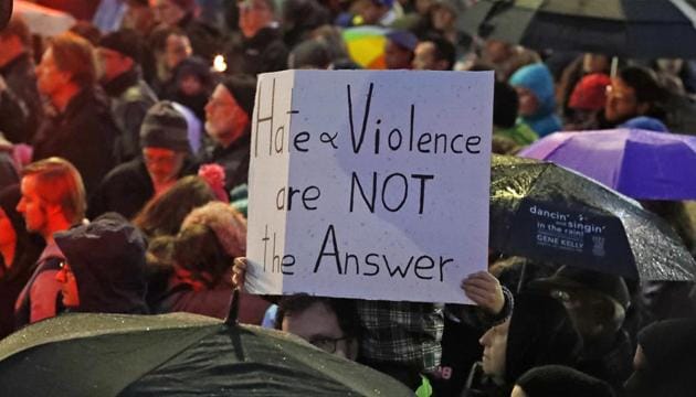 A young boy holds a sign at the intersection of Murray Ave. and Forbes Ave. in the Squirrel Hill section of Pittsburgh during a memorial vigil for the victims of the deadly shooting at the Tree of Life synagogue. (AP) A young boy holds a sign at the intersection of Murray Ave. and Forbes Ave. in the Squirrel Hill section of Pittsburgh during a memorial vigil for the victims of the deadly shooting at the Tree of Life synagogue. (AP)