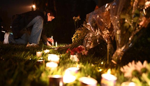 A woman kneels to place a candle outside the Tree of Life Synagogue after a shooting there left 11 people dead in the Squirrel Hill neighborhood of Pittsburgh on October 27, 2018. (AFP) A woman kneels to place a candle outside the Tree of Life Synagogue after a shooting there left 11 people dead in the Squirrel Hill neighborhood of Pittsburgh on October 27, 2018. (AFP)