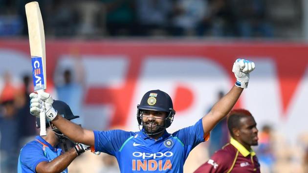Rohit Sharma (C) celebrates after scoring his century (100 runs) against West Indies. (AFP) 