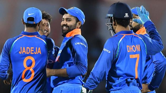India cricketer Rohit Sharma (C) celebrates with teammates after taking the catch to dismiss West Indies batsman Ashley Nurse during the fourth one day international (ODI) cricket match between India and West Indies at the Brabourne Stadium.(AFP)