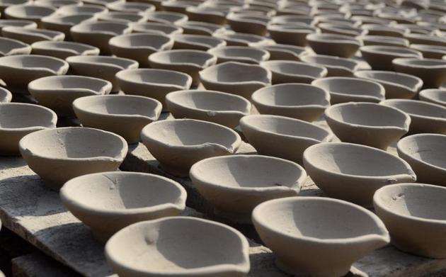 Diyas kept for drying by the potter before he starts painting them. (Ravindra Joshi/HT PHOTO) Diyas kept for drying by the potter before he starts painting them. (Ravindra Joshi/HT PHOTO)