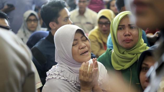 A relative of passengers prays as she and others wait for news at Depati Amir Airport. Spokesman Sutopo Purwo Nugroho said the aircraft, on a 1 hour and 10 minute flight to Pangkal Pinang on an island chain off Sumatra, was carrying 181 passengers, including one child and two babies, and eight crew members. (Hadi Sutrisno / AP)