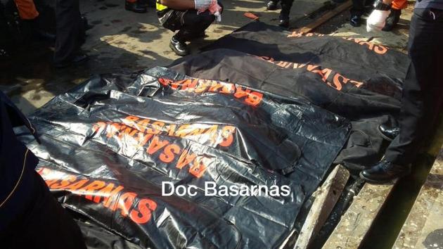 Rescue workers stand next to body bags at the port of Tanjung Priok, that are believed to be from Lion Air flight JT610, that took off from Jakarta and crashed into the sea, in Jakarta, Indonesia October 29, 2018 in this image obtained from social media.(Basarnas via Reuters)