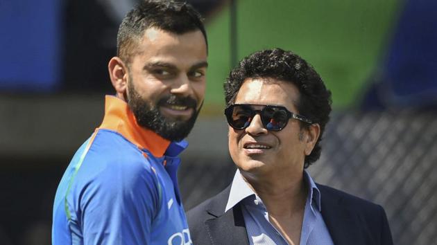 Virat Kohli and former cricketer Sachin Tendulkar before the 4th ODI cricket match between India and West Indies.(AP)