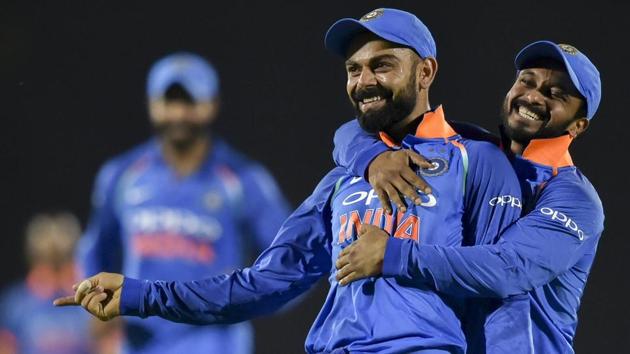 Virat Kohli celebrates with his teammates the dismissal of West Indies' batsman Kieran Powell. (AP)