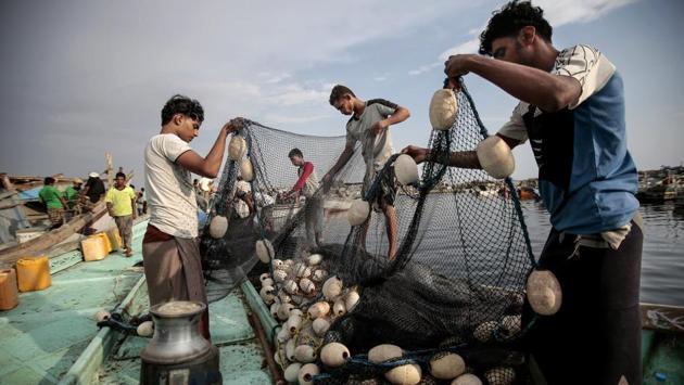 Fishermen load their nets on to a boat before a fishing trip. Everyone jumped in the water. They were so traumatized by the experience that some couldn’t go near the water for two weeks. (Hani Mohammed / AP)
