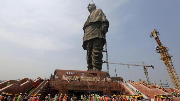 Workers stands near the under construction Statue of Unity at Kevadiya Colony, about 200 kilometers (125 miles) from Ahmadabad. Built at a cost of over Rs 2,300 crore, the statue is scheduled to be inaugurated tomorrow on Sardar Vallabhbhai Patel’s birth anniversary by Prime Minister Narendra Modi, five years after work began on the world’s largest statue. (Ajit Solanki / AP)