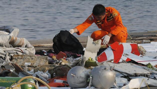 A member of Indonesian Search and Rescue Agency inspects debris believed to be from Lion Air passenger jet that crashed off Java Island at Tanjung Priok Port in Jakarta on Monday. (AP photo) A member of Indonesian Search and Rescue Agency inspects debris believed to be from Lion Air passenger jet that crashed off Java Island at Tanjung Priok Port in Jakarta on Monday. (AP photo)