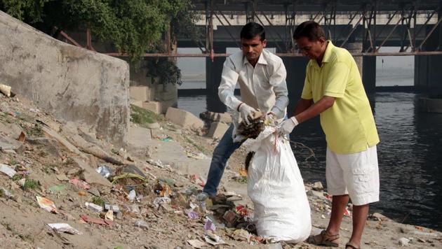 Volunteers clean up the Chhath Ghat at Yamuna River as part of the Clean Yamuna drive.