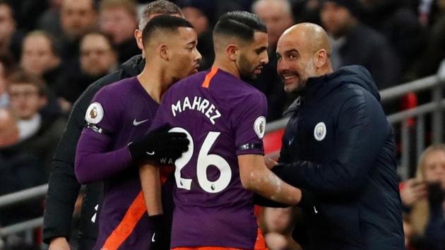 Manchester City players celebrate with manager Pep Guardiola on Monday.(Action Images via Reuters)