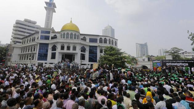 Sacked Sri Lankan PM Ranil Wickremesinghe’s party said about 1,00,000 people flooded the streets, while police sources estimated 25,000 even as scores of buses brought more demonstrators to the biggest rally since the constitutional crisis erupted. (AP) Sacked Sri Lankan PM Ranil Wickremesinghe’s party said about 1,00,000 people flooded the streets, while police sources estimated 25,000 even as scores of buses brought more demonstrators to the biggest rally since the constitutional crisis erupted. (AP)