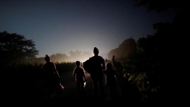 Their goal for the day was Pijijiapan. The town, next on a trek by thousands in a caravan that has so enraged US President Donald Trump he threatened to close the US-Mexico border and slash aid to Central America. Honduran boys Adonai, 5, and Denzel, 8, set off from Mapastepec still fogged with sleep. Their mother, Glenda Escobar, 33, clutched her youngest’s hand. Her friend, Maria, held onto Denzel’s T-shirt. (Ueslei Marcelino / REUTERS) Their goal for the day was Pijijiapan. The town, next on a trek by thousands in a caravan that has so enraged US President Donald Trump he threatened to close the US-Mexico border and slash aid to Central America. Honduran boys Adonai, 5, and Denzel, 8, set off from Mapastepec still fogged with sleep. Their mother, Glenda Escobar, 33, clutched her youngest’s hand. Her friend, Maria, held onto Denzel’s T-shirt. (Ueslei Marcelino / REUTERS)