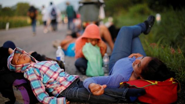 In Pijijiapan, hundreds turned the main square into a mix of carnival and refugee camp. The family headed for a warehouse-sized shelter reserved for anyone with children. In mid-afternoon, the warehouse was stifling with the crush of bodies. Escobar searched outside and set her plastic tarp under a tree. Two more stops and they would board a northbound freight train known as ‘La Bestia’ (the Beast), she said. (Ueslei Marcelino / REUTERS) In Pijijiapan, hundreds turned the main square into a mix of carnival and refugee camp. The family headed for a warehouse-sized shelter reserved for anyone with children. In mid-afternoon, the warehouse was stifling with the crush of bodies. Escobar searched outside and set her plastic tarp under a tree. Two more stops and they would board a northbound freight train known as ‘La Bestia’ (the Beast), she said. (Ueslei Marcelino / REUTERS)