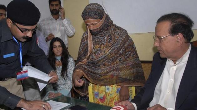 File photo of a police official taking the thumb print of Asia Bibi, a Pakistani Christian woman who was sentenced to death for blasphemy. Pakistan’s top court overturned her death sentence on October 31, 2018. (Reuters File) File photo of a police official taking the thumb print of Asia Bibi, a Pakistani Christian woman who was sentenced to death for blasphemy. Pakistan’s top court overturned her death sentence on October 31, 2018. (Reuters File)