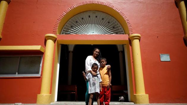Glenda Escobar, poses with her children Adonai and Denzel in San Pedro Tapanatepec, Mexico. All around, adults fell asleep, exhausted. But Adonai was sprinting for his third bottle of water. And Denzel was climbing a tree. “They’re as strong as adults,” she said. No sweat then, rousing them for the next day’s 3am start. (Ueslei Marcelino / REUTERS) Glenda Escobar, poses with her children Adonai and Denzel in San Pedro Tapanatepec, Mexico. All around, adults fell asleep, exhausted. But Adonai was sprinting for his third bottle of water. And Denzel was climbing a tree. “They’re as strong as adults,” she said. No sweat then, rousing them for the next day’s 3am start. (Ueslei Marcelino / REUTERS)