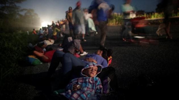 Just past 4am, under a star-streaked sky, the Central American migrants shouldered their bags and picked over broken sidewalks, - first as a trickle, then as a flood - to the edge of a Mexican town. They walked straight, without hesitation. Few spoke much. Their compass point was north, towards the United States. (Ueslei Marcelino / REUTERS) Just past 4am, under a star-streaked sky, the Central American migrants shouldered their bags and picked over broken sidewalks, - first as a trickle, then as a flood - to the edge of a Mexican town. They walked straight, without hesitation. Few spoke much. Their compass point was north, towards the United States. (Ueslei Marcelino / REUTERS)