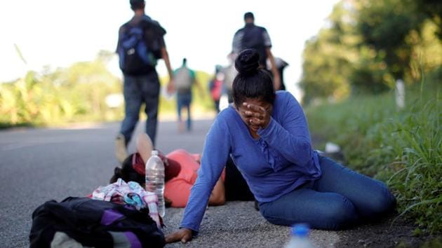 Escobar kneaded her shin. Agile and slight, she used to exercise regularly back home in the crime-wracked city of San Pedro Sula. But even the hardiest would have struggled to cover about 30 miles every day since she joined the caravan on October 14. If they were lucky, a passing car or minivan would give them a ride before the sun turned the day from sticky warm to sticky hot. (Ueslei Marcelino / REUTERS) Escobar kneaded her shin. Agile and slight, she used to exercise regularly back home in the crime-wracked city of San Pedro Sula. But even the hardiest would have struggled to cover about 30 miles every day since she joined the caravan on October 14. If they were lucky, a passing car or minivan would give them a ride before the sun turned the day from sticky warm to sticky hot. (Ueslei Marcelino / REUTERS)