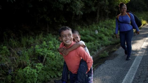 By 9am, two hours past sunrise, the first hitchhikers reached Pijijiapan. Far behind, the Escobars walked, paused, zig-zagged into the bushes, walked, and stopped again. “We’ve been going so many days,” Escobar said, watching her sons flag, then suddenly leap to life and give each other piggy backs. “Should we rest here a bit?” (Ueslei Marcelino / REUTERS) By 9am, two hours past sunrise, the first hitchhikers reached Pijijiapan. Far behind, the Escobars walked, paused, zig-zagged into the bushes, walked, and stopped again. “We’ve been going so many days,” Escobar said, watching her sons flag, then suddenly leap to life and give each other piggy backs. “Should we rest here a bit?” (Ueslei Marcelino / REUTERS)