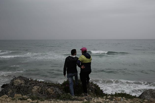 Ahmed Ayouby, 32, left, and Mounir Aguida, 30, who want to leave Tunisia, stand at the beach where migrants leave for Italy, in the town of Ras Jabal, Bizerte, Tunisia, on April 14, 2018. In late August 2018, he crammed into a raft with seven friends, feeling the waves slam the flimsy bow. At the last minute he and another young man jumped out. “It didn’t feel right,” Aguida said. There has been no word from the other six. (AP Photo/Nariman El-Mofty) (AP) Ahmed Ayouby, 32, left, and Mounir Aguida, 30, who want to leave Tunisia, stand at the beach where migrants leave for Italy, in the town of Ras Jabal, Bizerte, Tunisia, on April 14, 2018. In late August 2018, he crammed into a raft with seven friends, feeling the waves slam the flimsy bow. At the last minute he and another young man jumped out. “It didn’t feel right,” Aguida said. There has been no word from the other six. (AP Photo/Nariman El-Mofty) (AP)