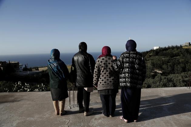 In this April 12, 2018 photo, women whose sons went missing look at the shoreline in the town of Ras Jabal, Bizerte, Tunisia. An Associated Press tally has documented at least 56,800 migrants dead or missing worldwide from 2014 to 2018 - almost double the number found in the world’s only official attempt to count them, by the U.N.’s International Organization for Migration. (AP Photo/Nariman El-Mofty) (AP) In this April 12, 2018 photo, women whose sons went missing look at the shoreline in the town of Ras Jabal, Bizerte, Tunisia. An Associated Press tally has documented at least 56,800 migrants dead or missing worldwide from 2014 to 2018 - almost double the number found in the world’s only official attempt to count them, by the U.N.’s International Organization for Migration. (AP Photo/Nariman El-Mofty) (AP)