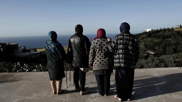 Women whose sons went missing look at the shoreline in the town of Ras Jabal, Bizerte, Tunisia. The boys grew up within sight of the sea that took them away, rambling along paths and climbing rocks that would later be the launching pad for their flimsy rafts. (Nariman El-Mofty / AP) Women whose sons went missing look at the shoreline in the town of Ras Jabal, Bizerte, Tunisia. The boys grew up within sight of the sea that took them away, rambling along paths and climbing rocks that would later be the launching pad for their flimsy rafts. (Nariman El-Mofty / AP)