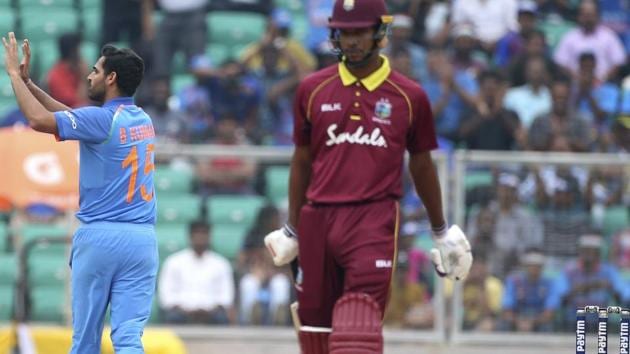 India's Bhuvneshwar Kumar, left, celebrates the dismissal of West Indies' Kieran Powell, right, during the fifth and last one-day international cricket match between India and West Indies. (AP)