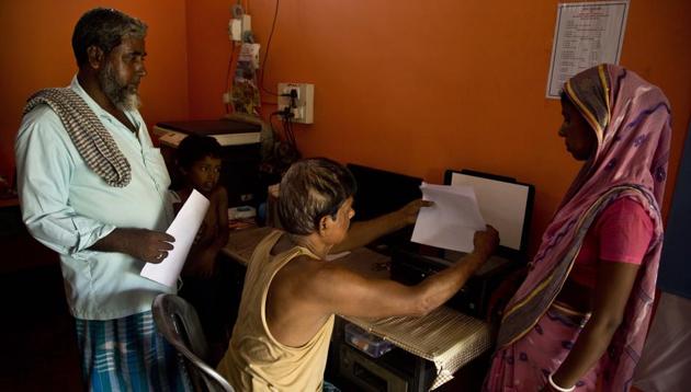 A man scans the documents of people whose names were left out in the National Register of Citizens (NRC) draft near a NRC center on the outskirts of Guwahati, Assam , Aug. 13, 2018. (AP) A man scans the documents of people whose names were left out in the National Register of Citizens (NRC) draft near a NRC center on the outskirts of Guwahati, Assam , Aug. 13, 2018. (AP)