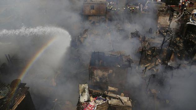 Firefighters try to douse the fire at a slum in Mumbai on October 30, 2018. (Rafiq Maqbool / AP) Firefighters try to douse the fire at a slum in Mumbai on October 30, 2018. (Rafiq Maqbool / AP)
