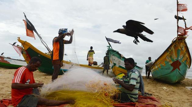 A fishermen mends a net as dark clouds loom over the sky ahead of monsoon rains at Pattinapakkam beach, in Chennai on October 31, 2018. (Arun Sankar / AFP) A fishermen mends a net as dark clouds loom over the sky ahead of monsoon rains at Pattinapakkam beach, in Chennai on October 31, 2018. (Arun Sankar / AFP)