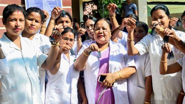 Auxiliary Nurse Midwifery (ANM) and Lady Health Supervisors (LHS) wear black bandages as part of their one-month agitation programme against the government, demanding an immediate fill up of the vacant post of ANM and LHS in different hospitals at East Guwahati Dispensary in Chandmari. (PTI) Auxiliary Nurse Midwifery (ANM) and Lady Health Supervisors (LHS) wear black bandages as part of their one-month agitation programme against the government, demanding an immediate fill up of the vacant post of ANM and LHS in different hospitals at East Guwahati Dispensary in Chandmari. (PTI)