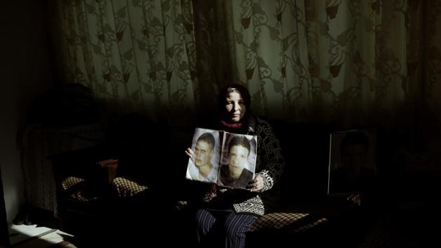 Fathia Jejli holds a photo of her son, Hossam Edin Jejli (R), and her nephew, Hamed Ben Brayek, who went missing in 2011, at her home in the town of Ras Jabal. As global migration soars to record highs, far less visible has been its toll: The tens of thousands of people who die or simply disappear during their journeys, never to be seen again. (Nariman El-Mofty / AP) Fathia Jejli holds a photo of her son, Hossam Edin Jejli (R), and her nephew, Hamed Ben Brayek, who went missing in 2011, at her home in the town of Ras Jabal. As global migration soars to record highs, far less visible has been its toll: The tens of thousands of people who die or simply disappear during their journeys, never to be seen again. (Nariman El-Mofty / AP)