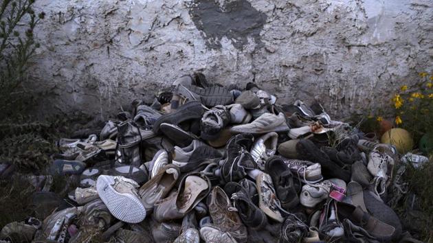 Migrants’ shoes which were retrieved by artist Mohsen Lahzib in Zarzis, Tunisia. The belongings are painstakingly gathered to create beauty out of sorrow — a torn pink bra, a child’s worn jacket, a pack of cigarettes. (Nariman El-Mofty / AP) Migrants’ shoes which were retrieved by artist Mohsen Lahzib in Zarzis, Tunisia. The belongings are painstakingly gathered to create beauty out of sorrow — a torn pink bra, a child’s worn jacket, a pack of cigarettes. (Nariman El-Mofty / AP)