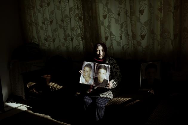 In this April 12, 2018 photo, Fathia Jejli holds a photo of her son, Hossam Edin Jejli, right, and her nephew, Hamed Ben Brayek, who went missing in 2011, at her home in the town of Ras Jabal, Bizerte, Tunisia. As global migration has soared to record highs, far less visible has been its toll: The tens of thousands of people who die or simply disappear during their journeys, never to be seen again.(AP Photo/Nariman El-Mofty) (AP) In this April 12, 2018 photo, Fathia Jejli holds a photo of her son, Hossam Edin Jejli, right, and her nephew, Hamed Ben Brayek, who went missing in 2011, at her home in the town of Ras Jabal, Bizerte, Tunisia. As global migration has soared to record highs, far less visible has been its toll: The tens of thousands of people who die or simply disappear during their journeys, never to be seen again.(AP Photo/Nariman El-Mofty) (AP)