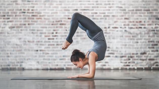 young woman doing yoga meditation exercises stretching 74fc34f4 dd84 11e8 b6b1 54a396001ae0