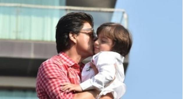 Shah Rukh Khan plants a kiss on AbRam’s cheek as he greets his fans at his home, Mannat .