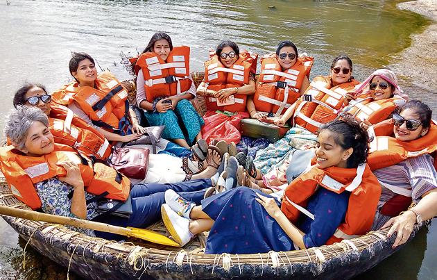 Radhika Naware (third from left), founder of Treasured Holidays, a niche travel company that offers designer craft and textile trails across India, with her clients on a coracle (a boat made of wickerwork, propelled with a paddle) ride, in Hampi during one of the trails.(HT)